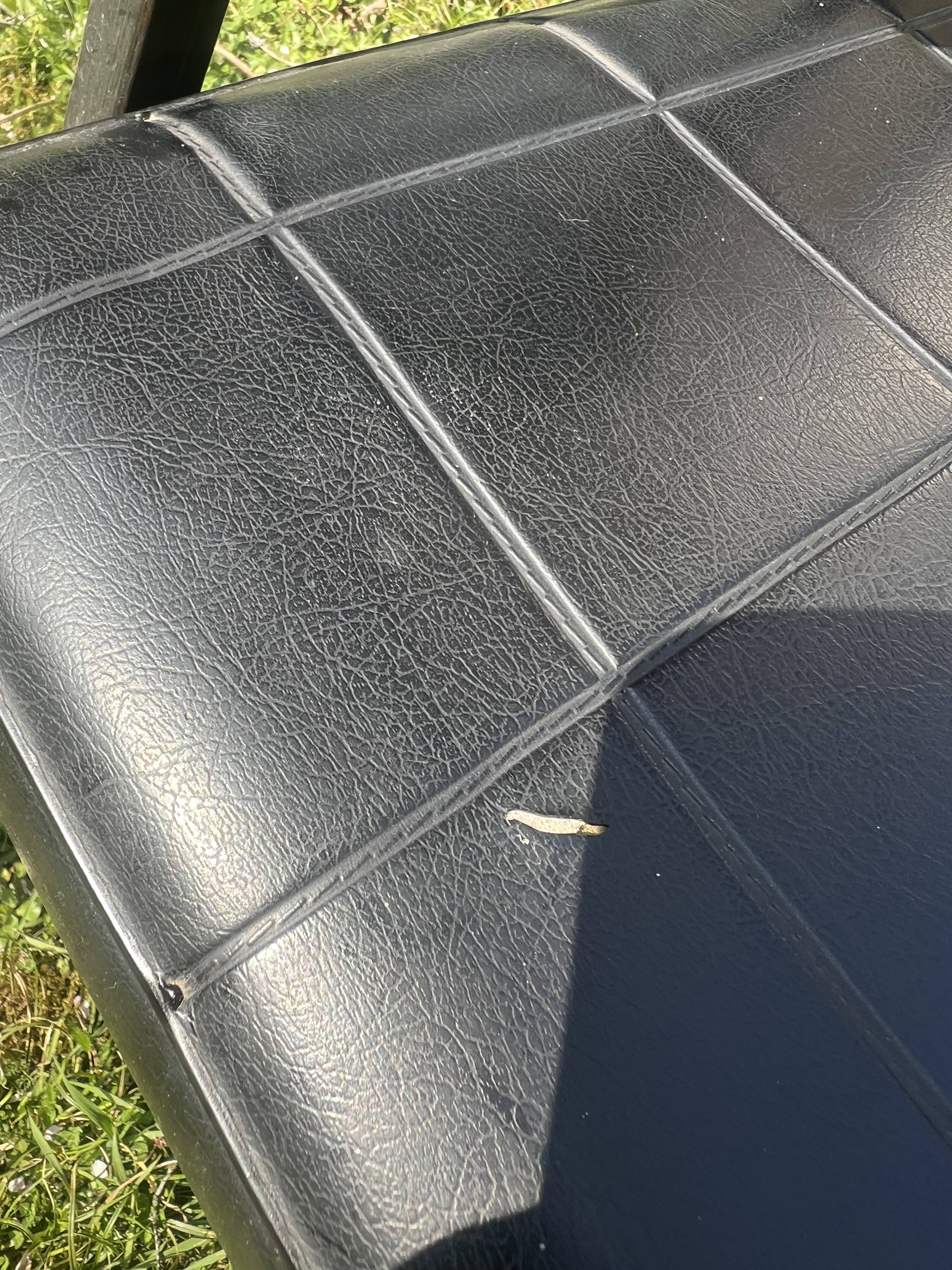 Pair of vintage industrial armchairs in black imitation leather and metal legs