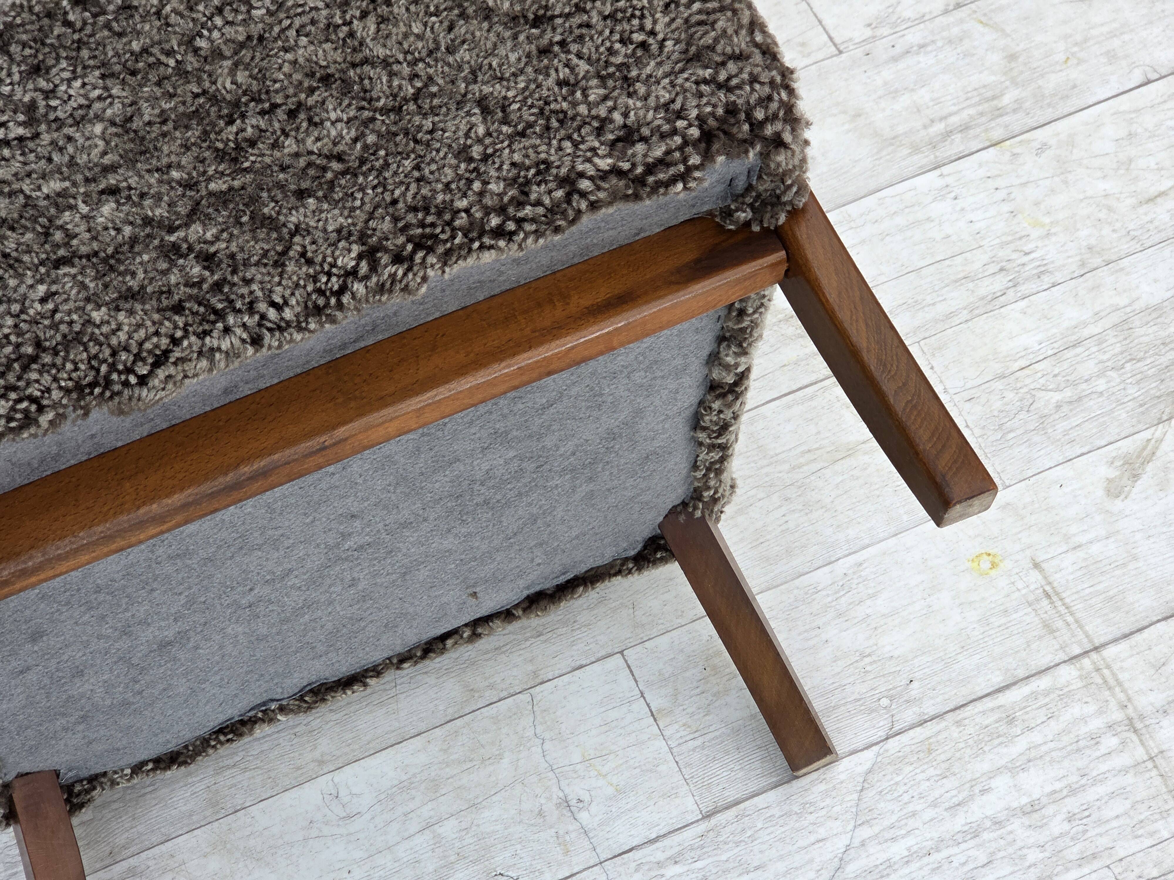 1960s, reupholstered Danish armchair, with stool, genuine sheepskin.