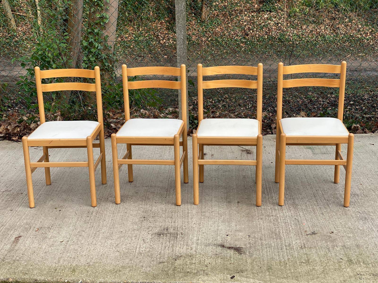 4 solid wood and white leather chairs