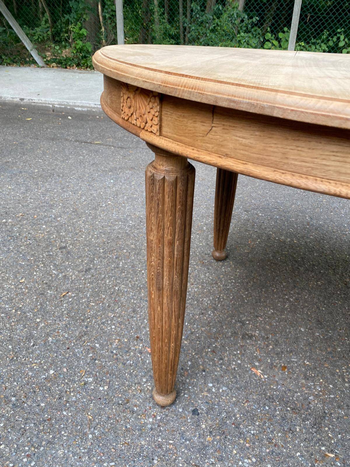 Large stripped solid oak dining table in Louis XVI style with 3 extensions.