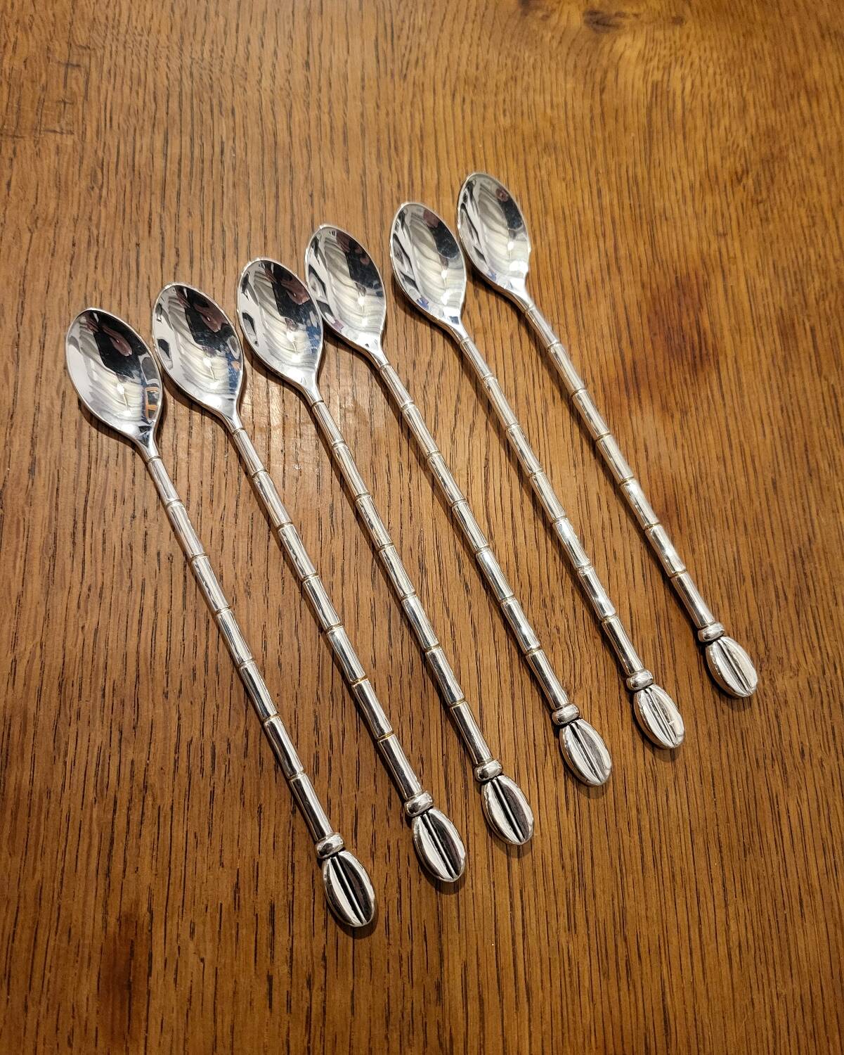 6 long silver-plated metal spoons