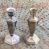 Pair of metal candlesticks, chiseled with a statuette in front, rose pattern in relief, art deco