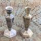 Pair of metal candlesticks, chiseled with a statuette in front, rose pattern in relief, art deco