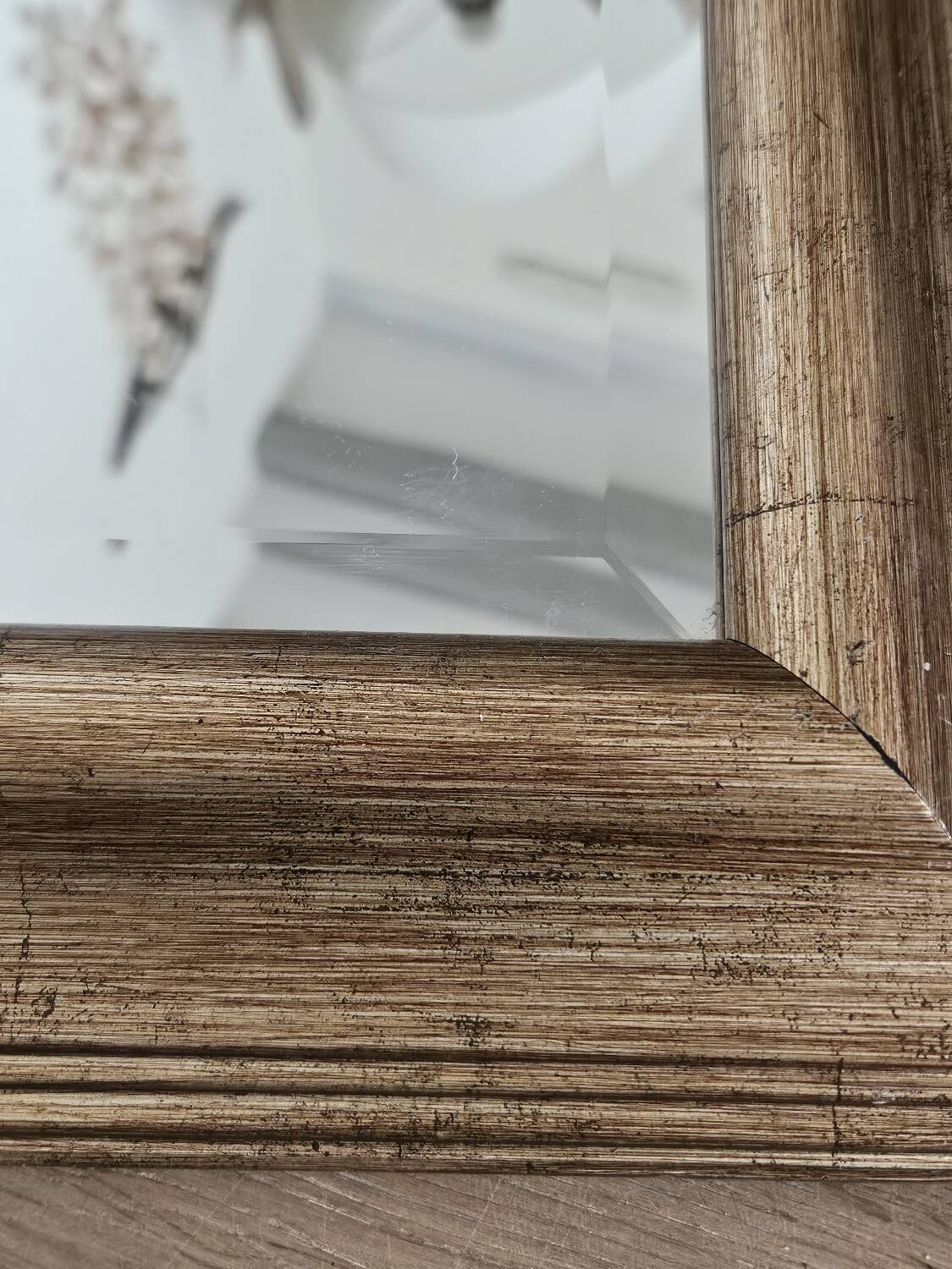 Beveled mirror under gold frame