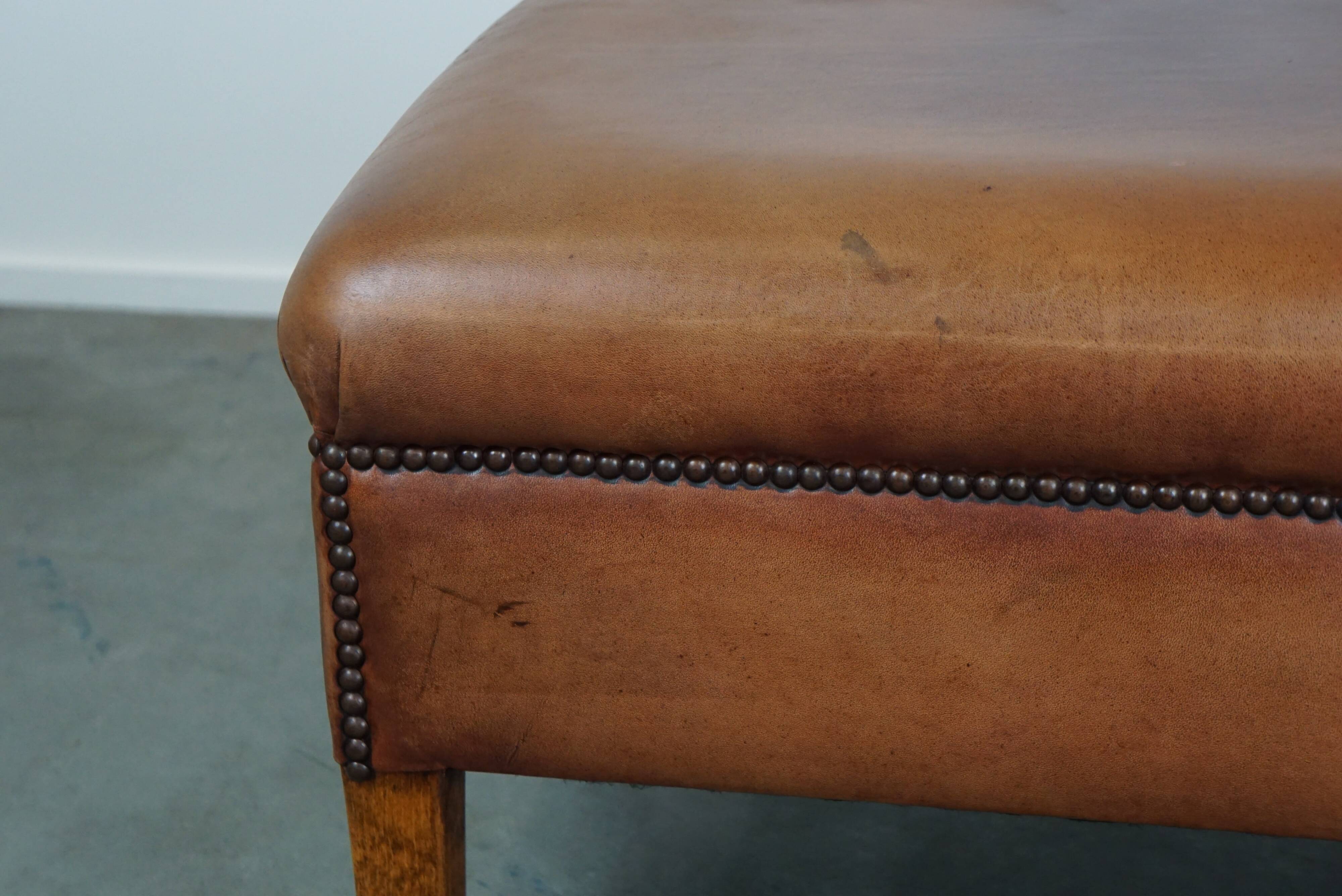English-style leather ottoman in cognac-colored leather