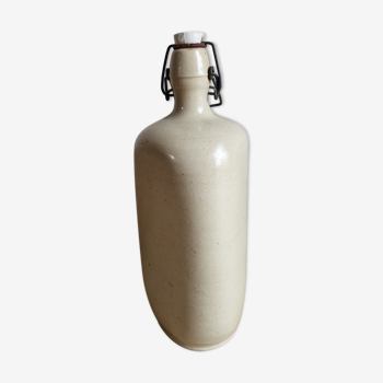 Old bottle of beige sandstone hot water bottle