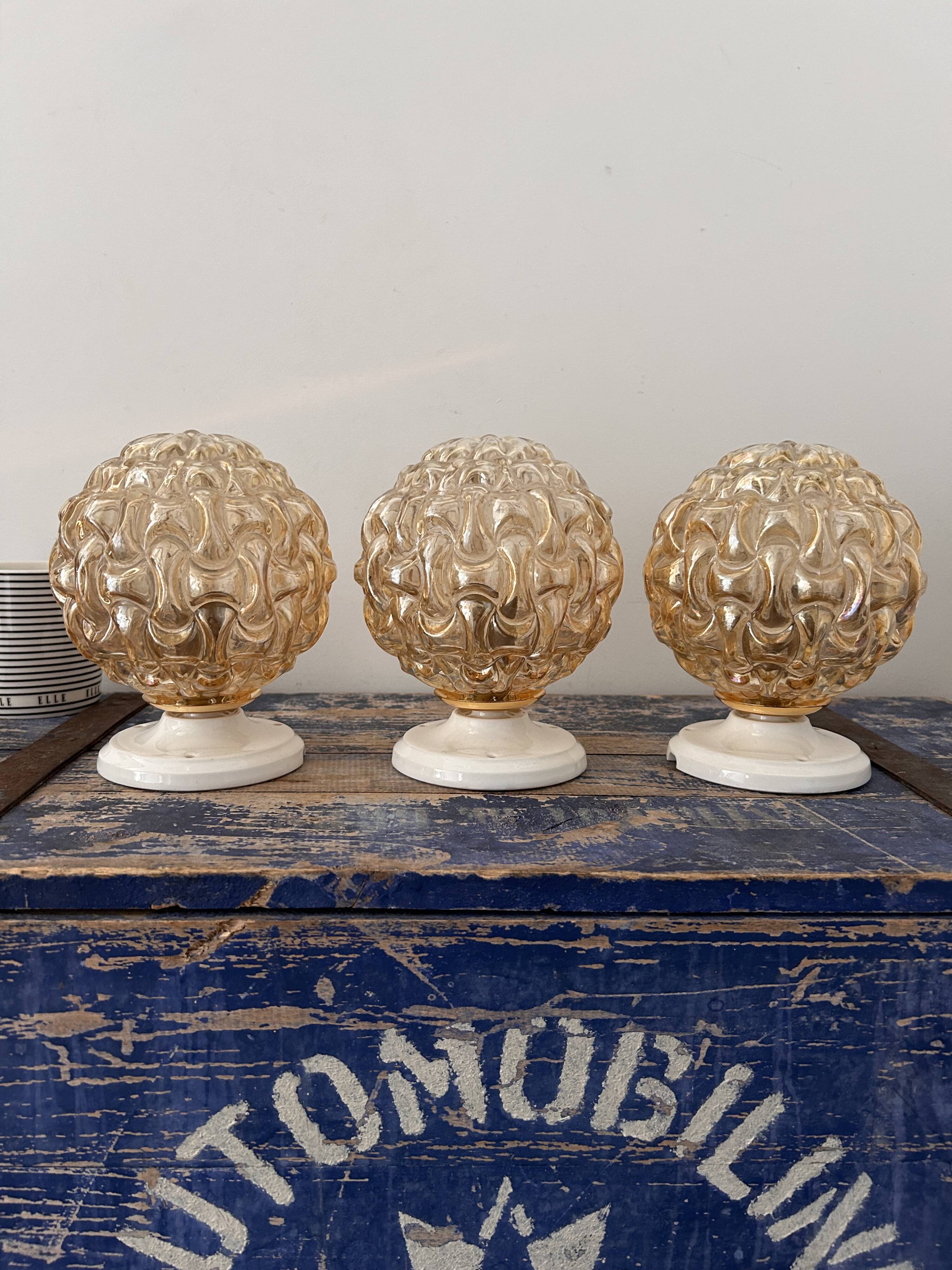 Trio of golden globe wall or ceiling lights