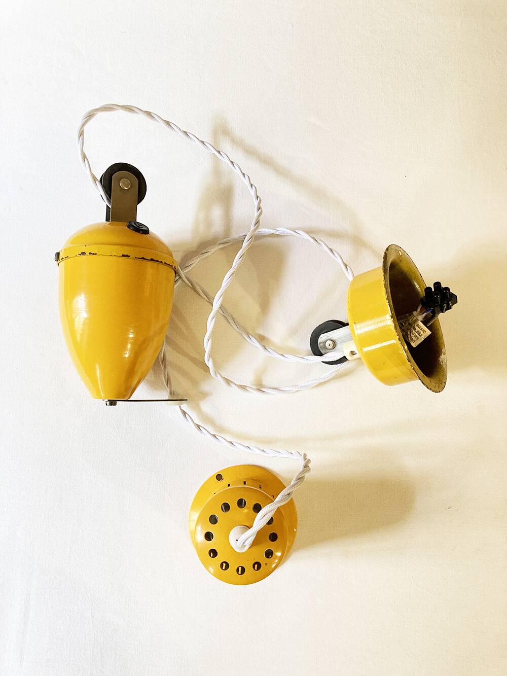 Suspension rises and falls in yellow painted metal