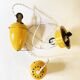 Suspension rises and falls in yellow painted metal