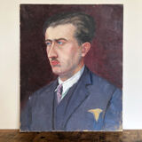 Old oil painting on cardboard portrait of a man in a blue suit