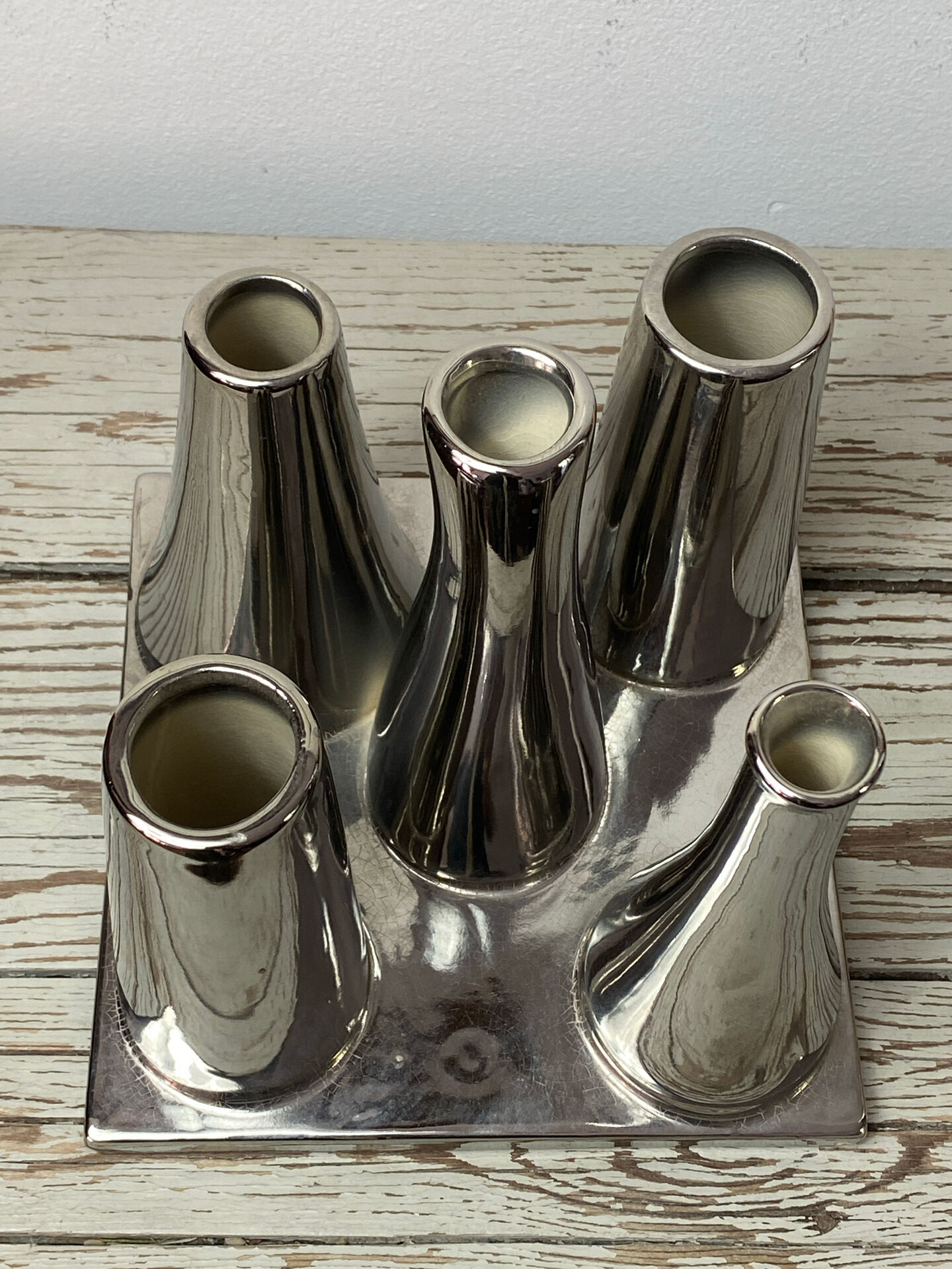 Asymmetrical multitube vase on a base, in silvered ceramic, 1970.