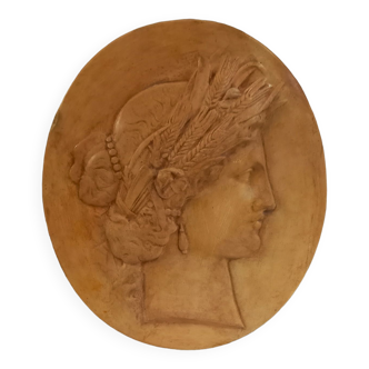 Plaster medallion, high relief, yellow ochre patina, representing the Roman deity Ceres