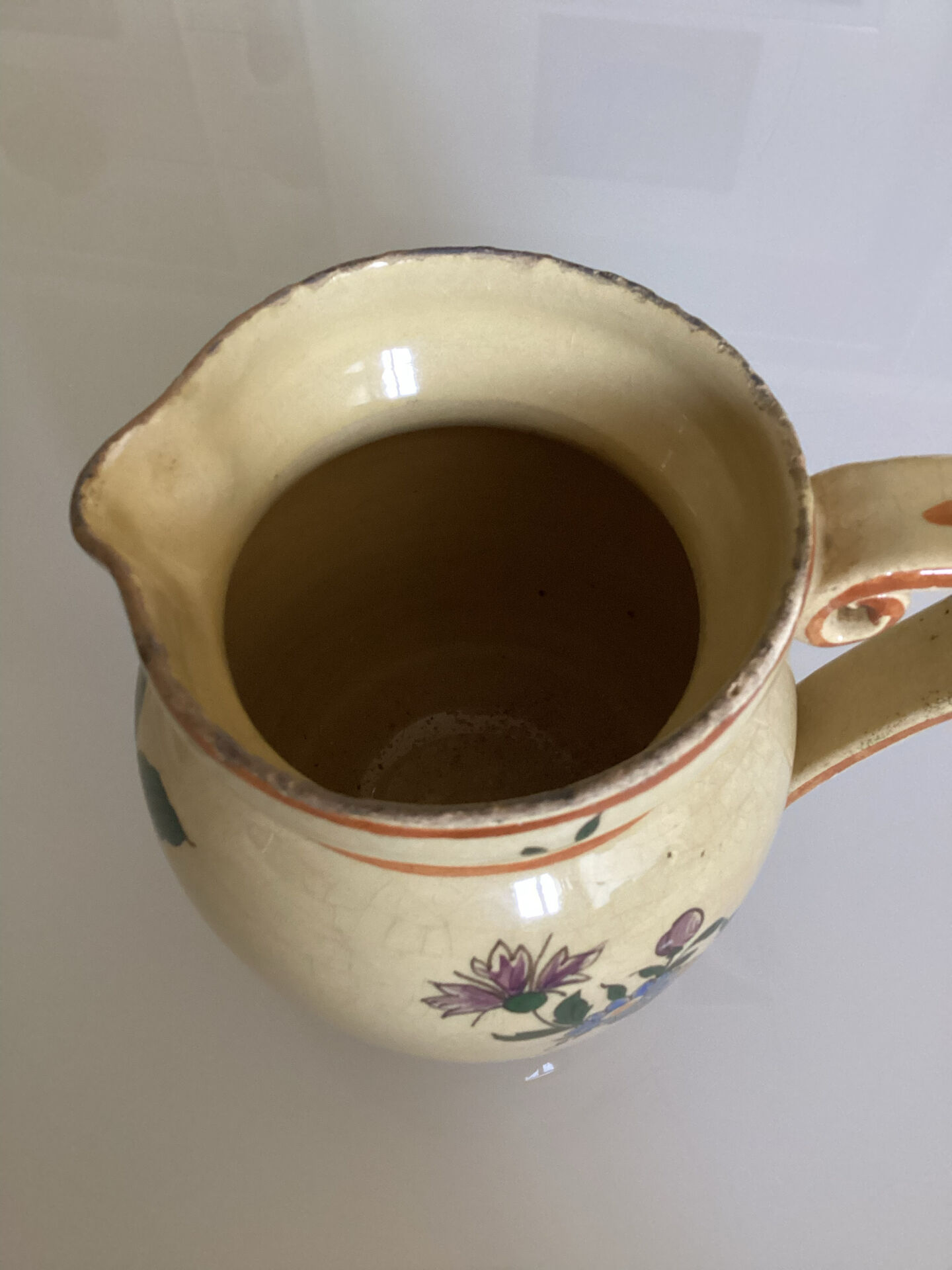 Old ceramic jug with floral decoration