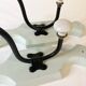 Antique metal and porcelain coat hooks, painted wooden support