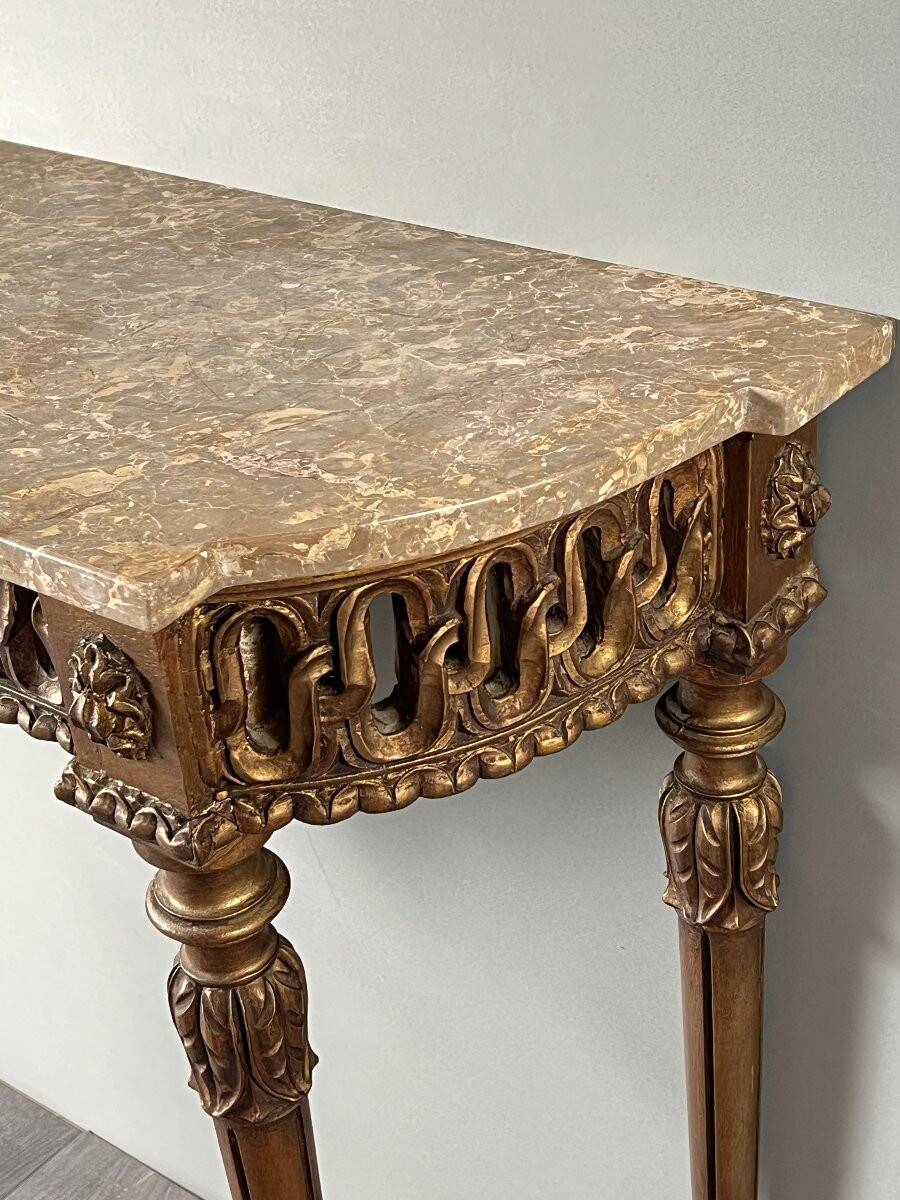 Louis XVI style console in carved wood with a gilded patina, 19th century.