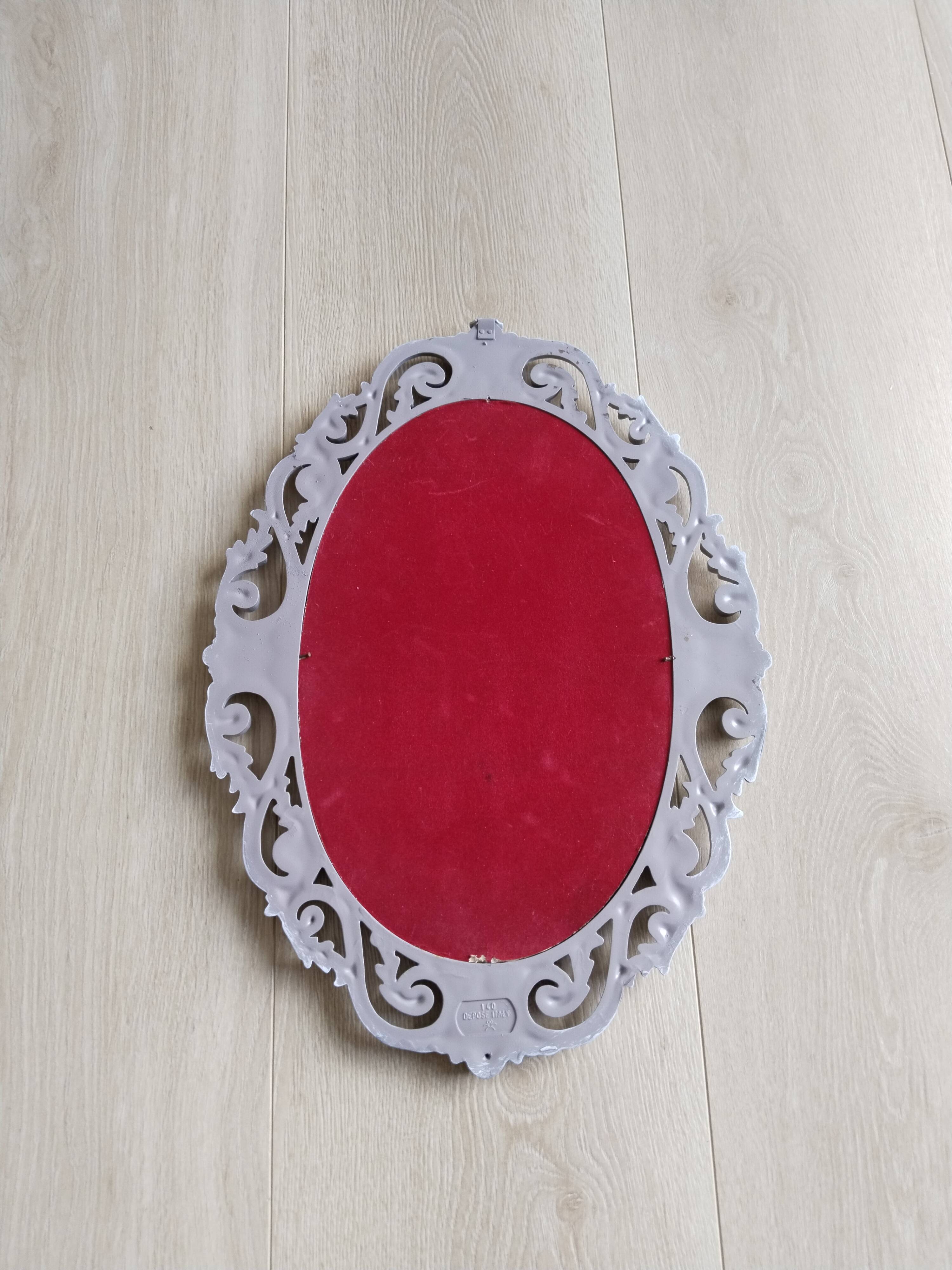 Louis XVI style patinated oval mirror