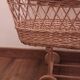 Vintage wicker cradle with wheels