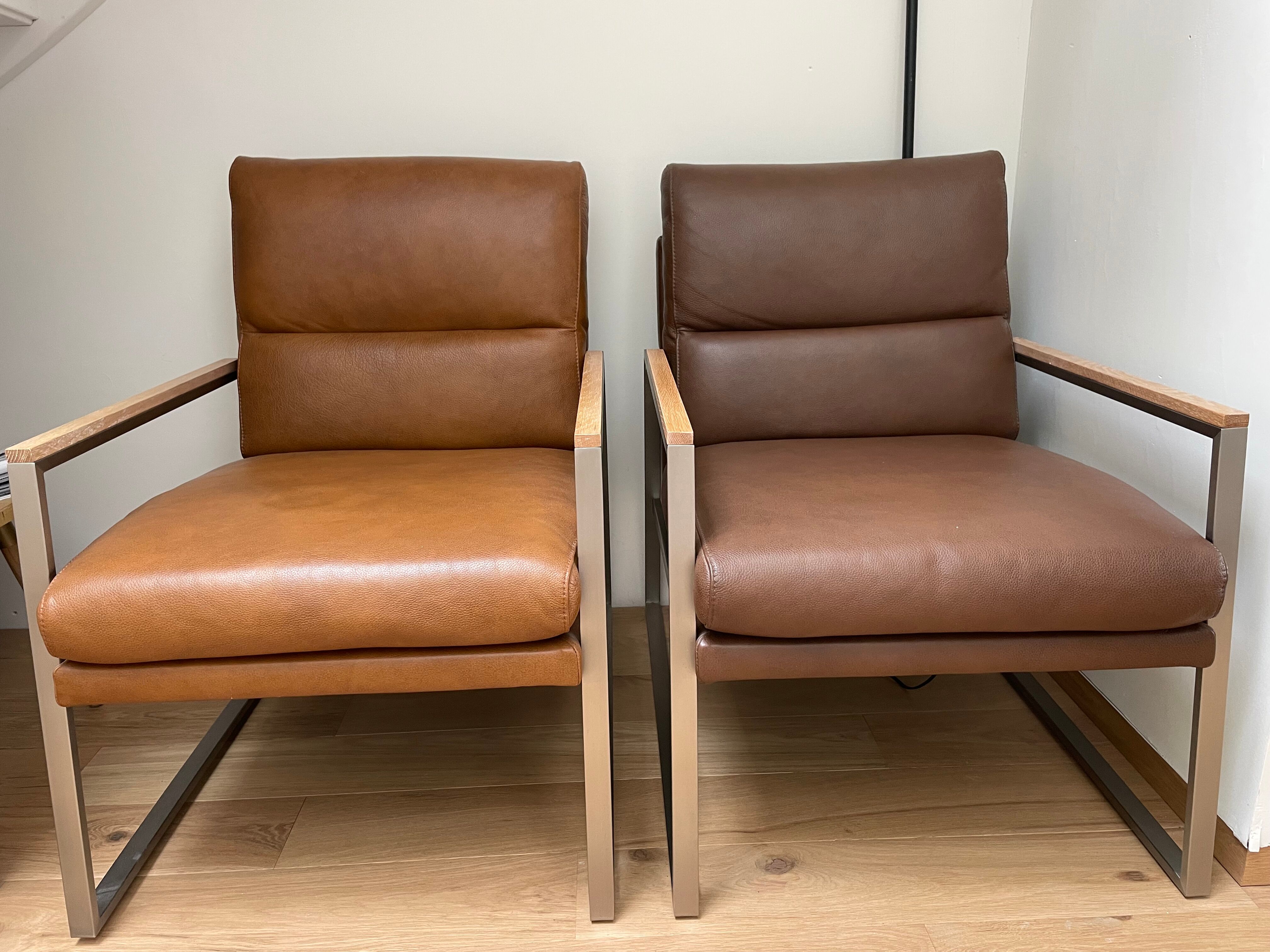 A pair genuine leather armchairs.