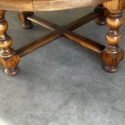 Vintage wooden turned coffee table with leather and astrological decoration.