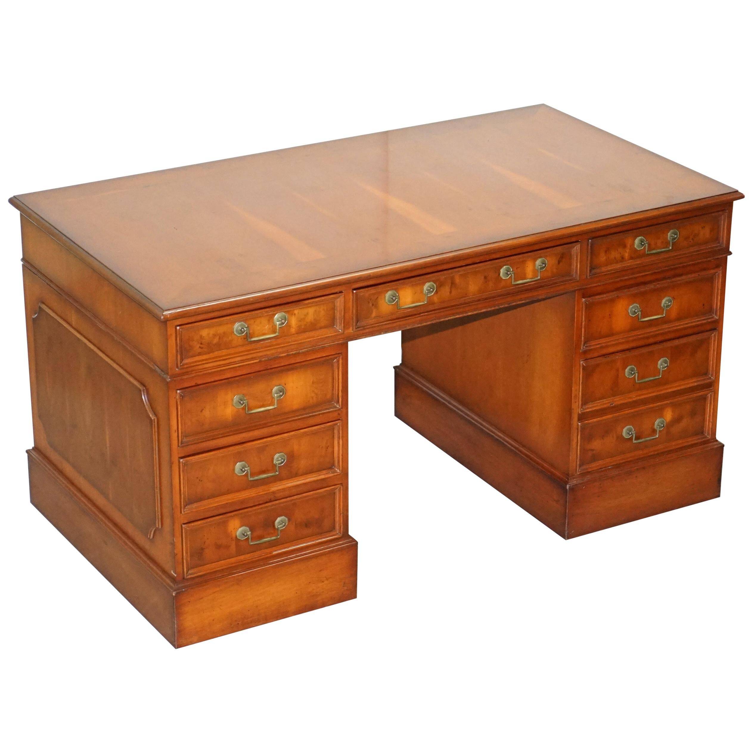 Partner desk with double pedestal in burr yew wood with decorated top.