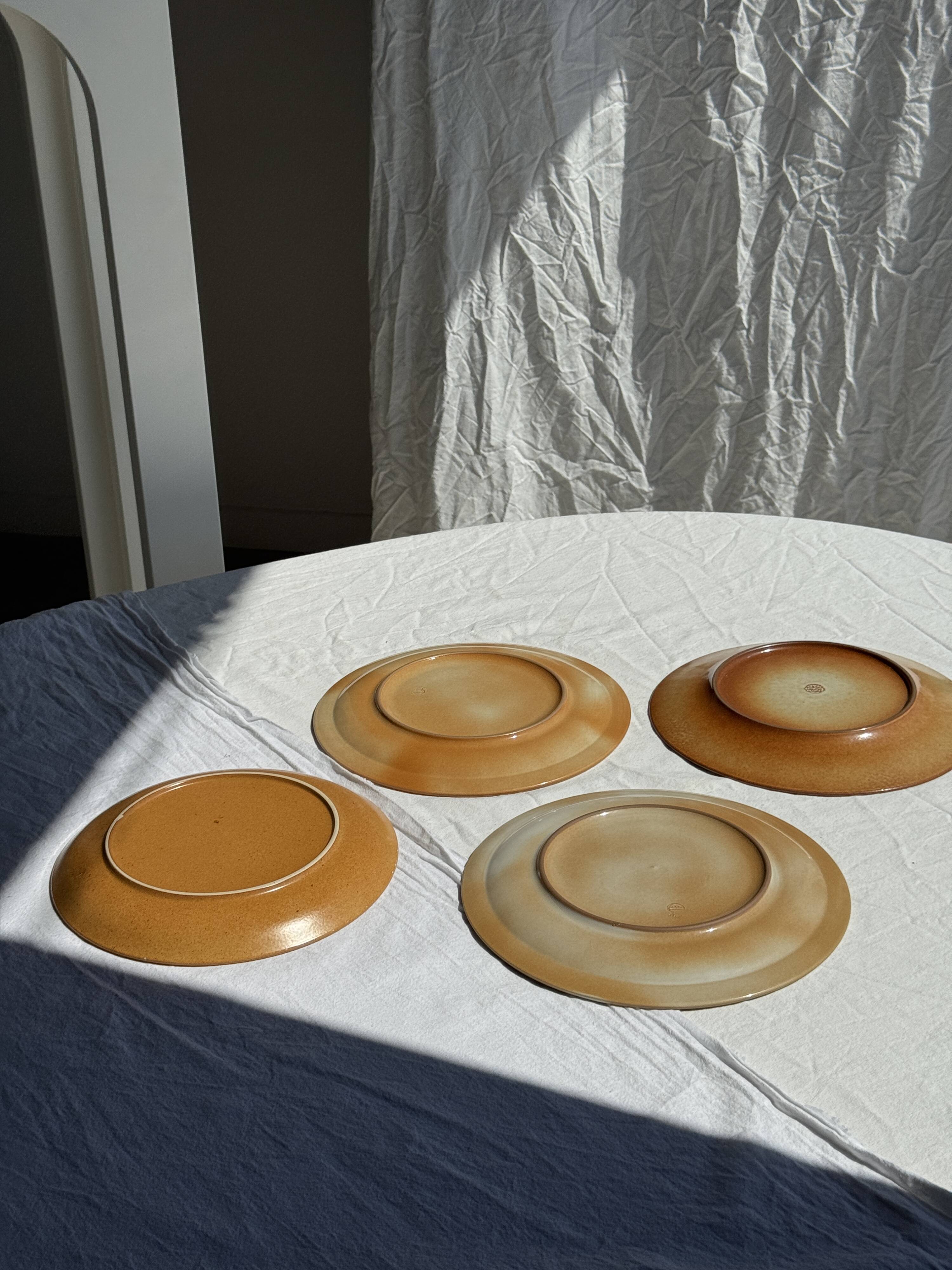 Set of 4 vintage stoneware plates, including 2 with floral motifs