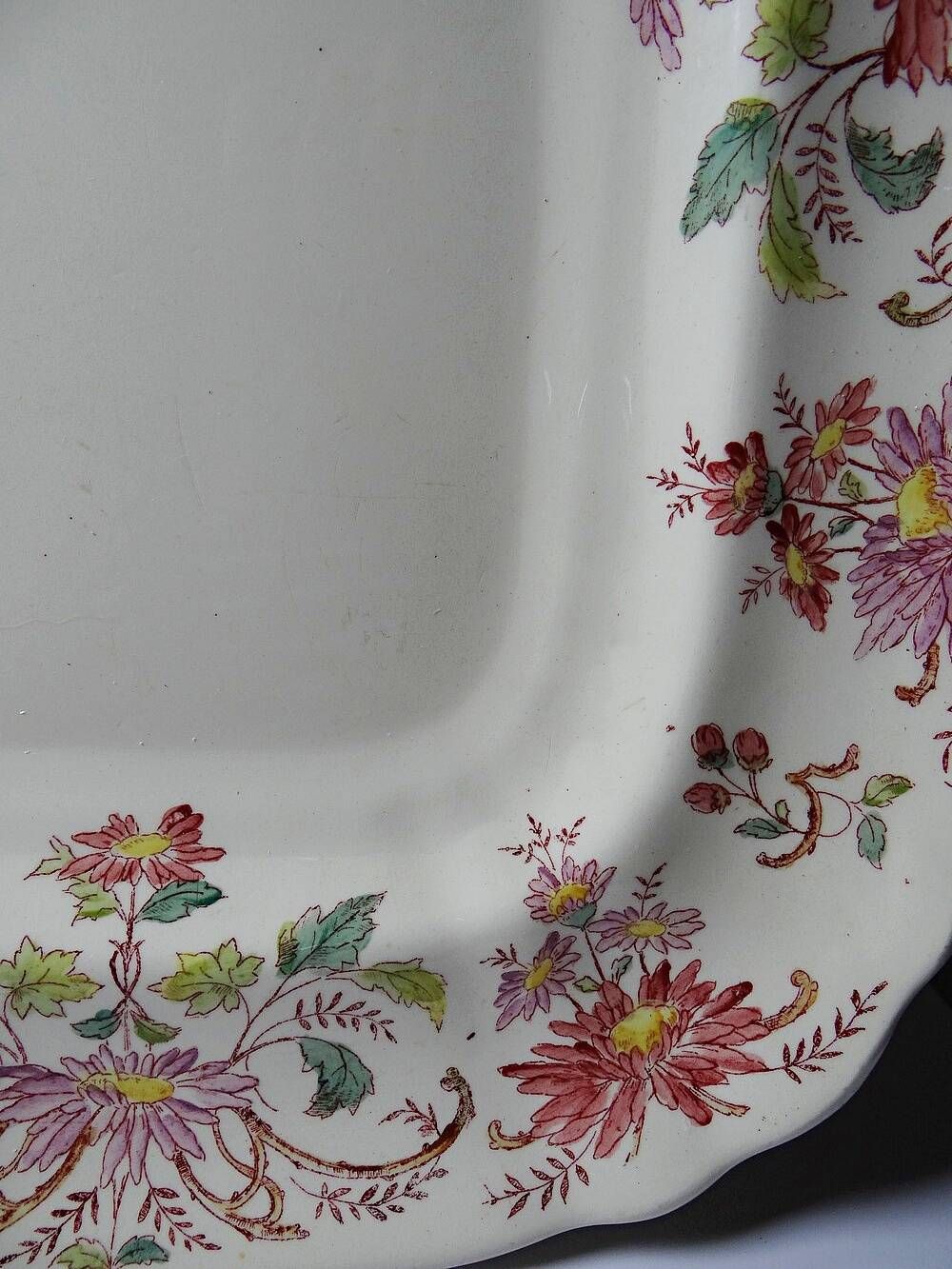 Antique Longchamp serving platter with polychrome daisies in ironstone.