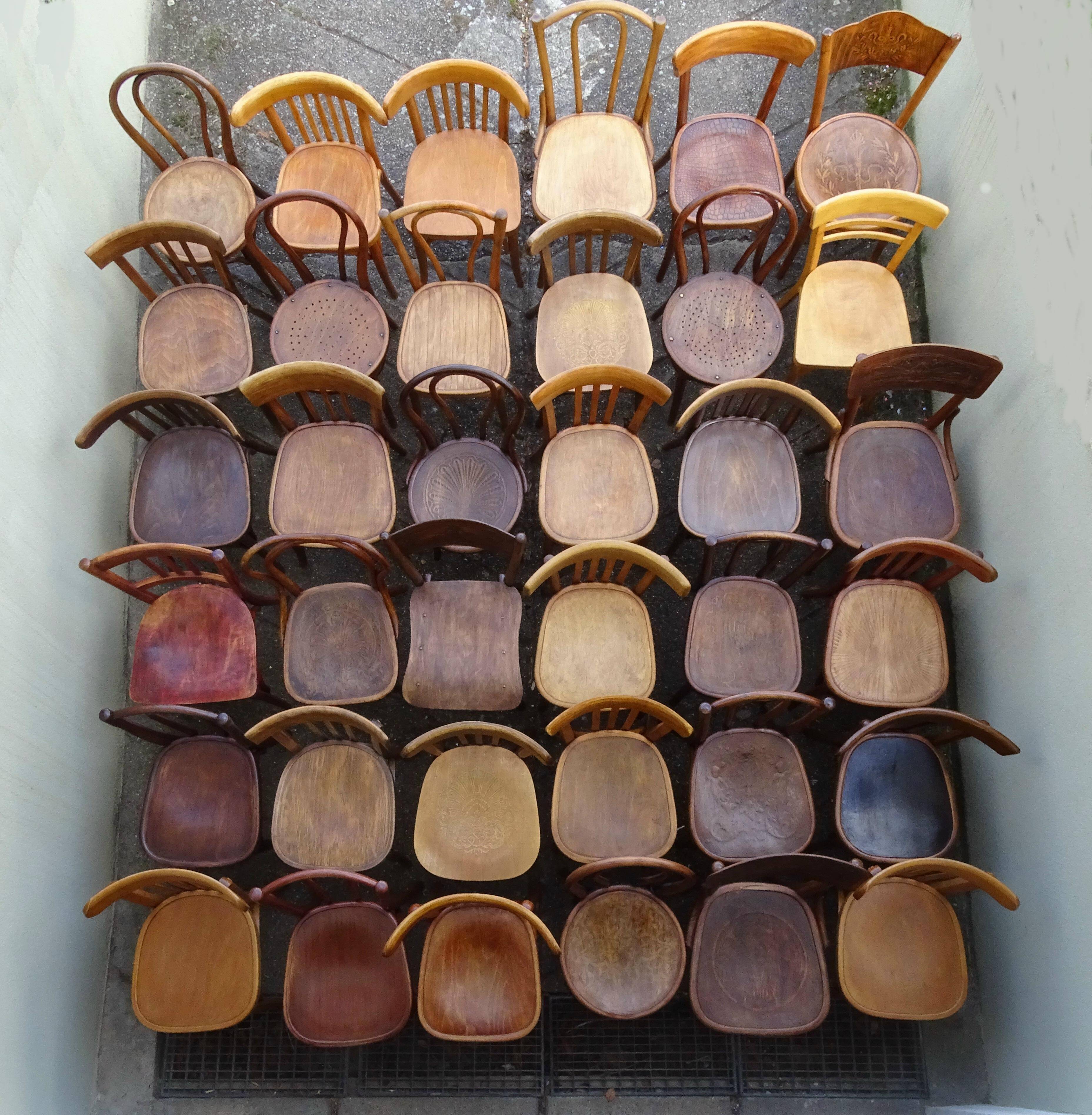 Set of 36 mismatched Bistrot chairs, 1920 to 1950, wooden seats.