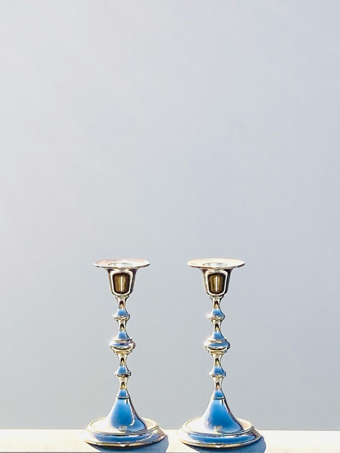 Two antique metal candle holders