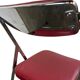 Vintage folding chair in red faux leather with a chrome frame.
