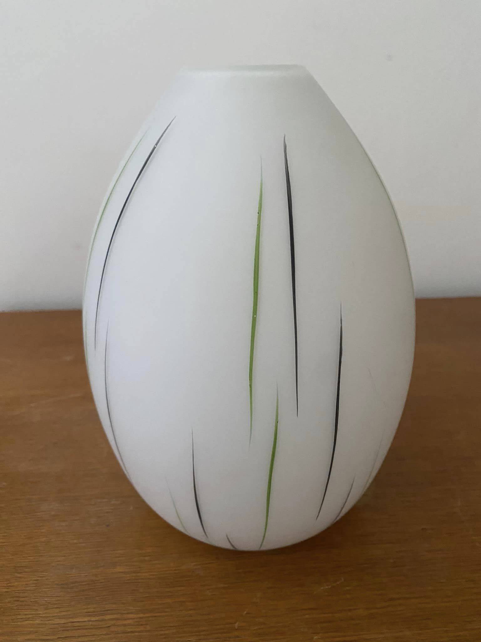 White opaline tulip with dark green and gray streaks. Oblong shape.