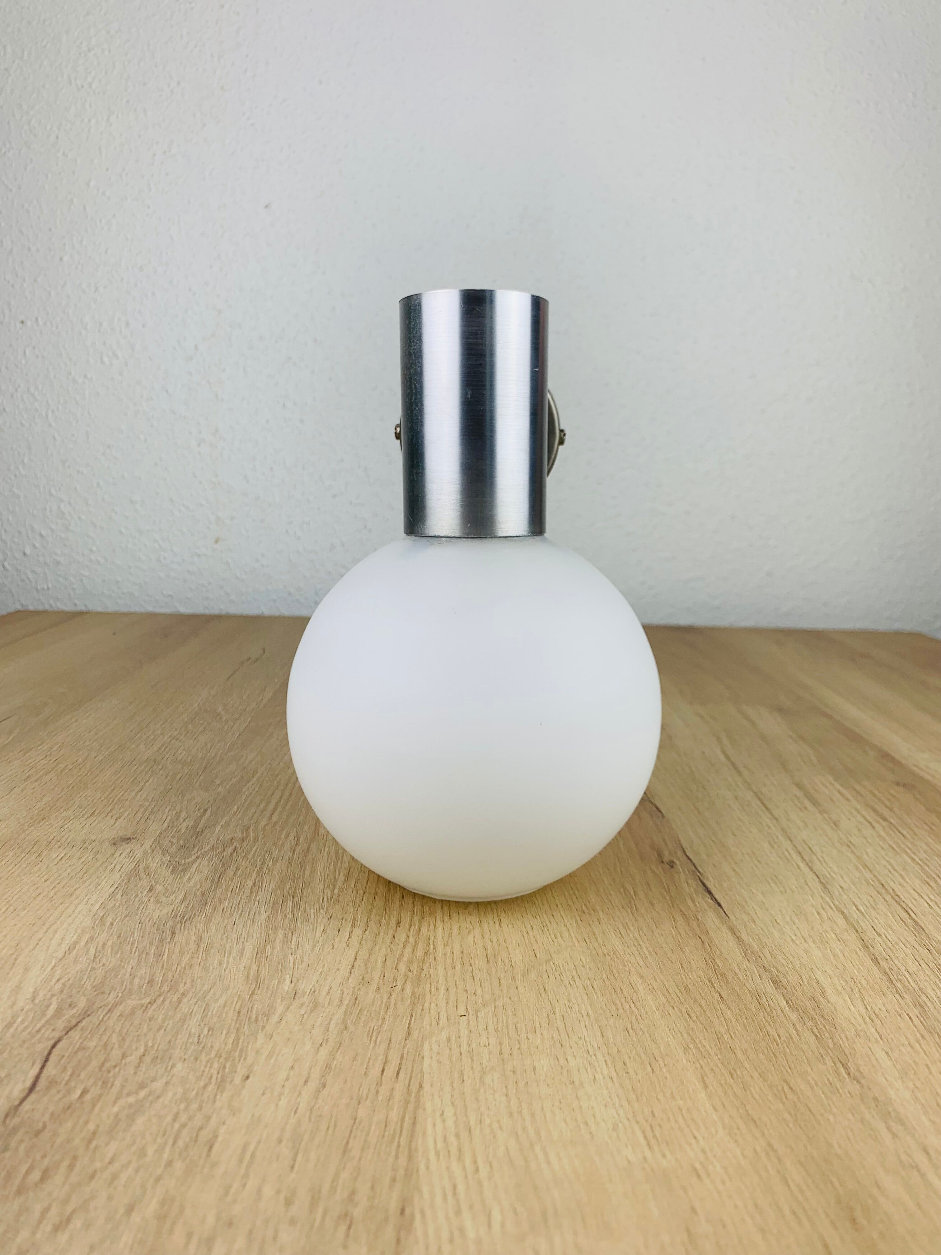 Space age opaline globe wall light, adjustable, and brushed metal, 1960s.