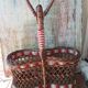 Bottle holder in braided wicker, rattan and scoubidou