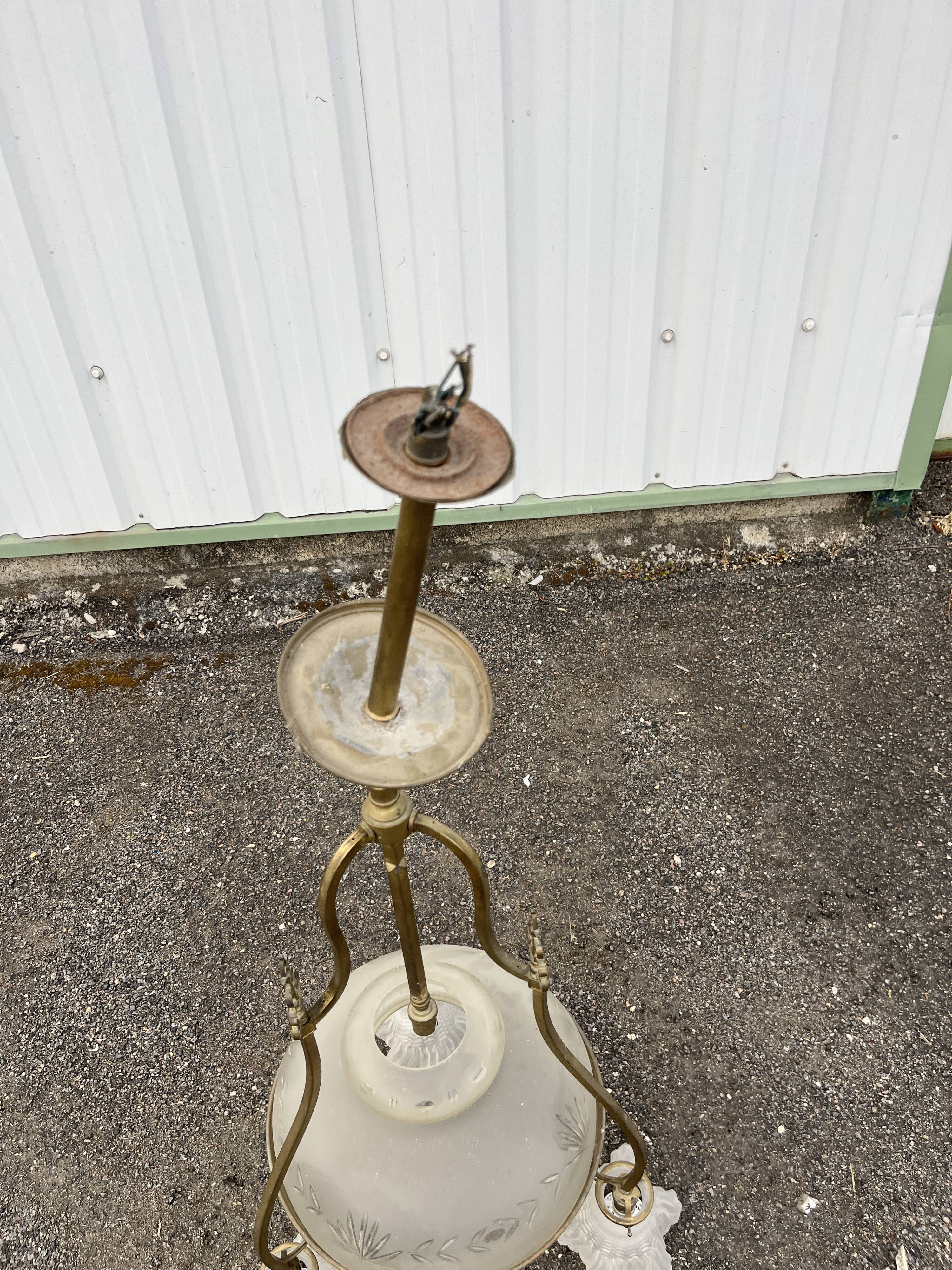 Antique brass chandelier with 3 lights and frosted glass shades.