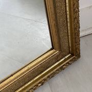 Small wooden mirror with gilded stucco in the Louis XVI style.