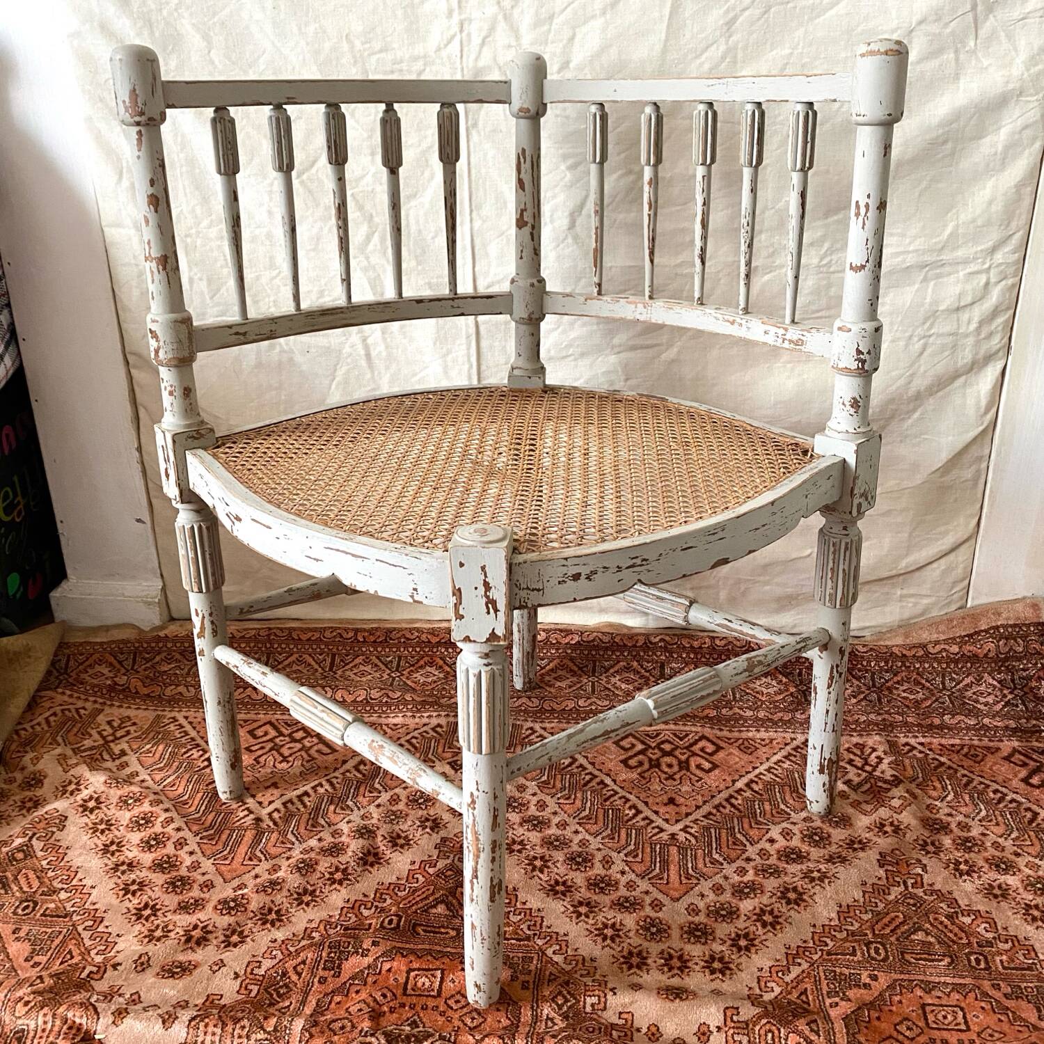 19th-century corner fireplace armchair, wood and cane.