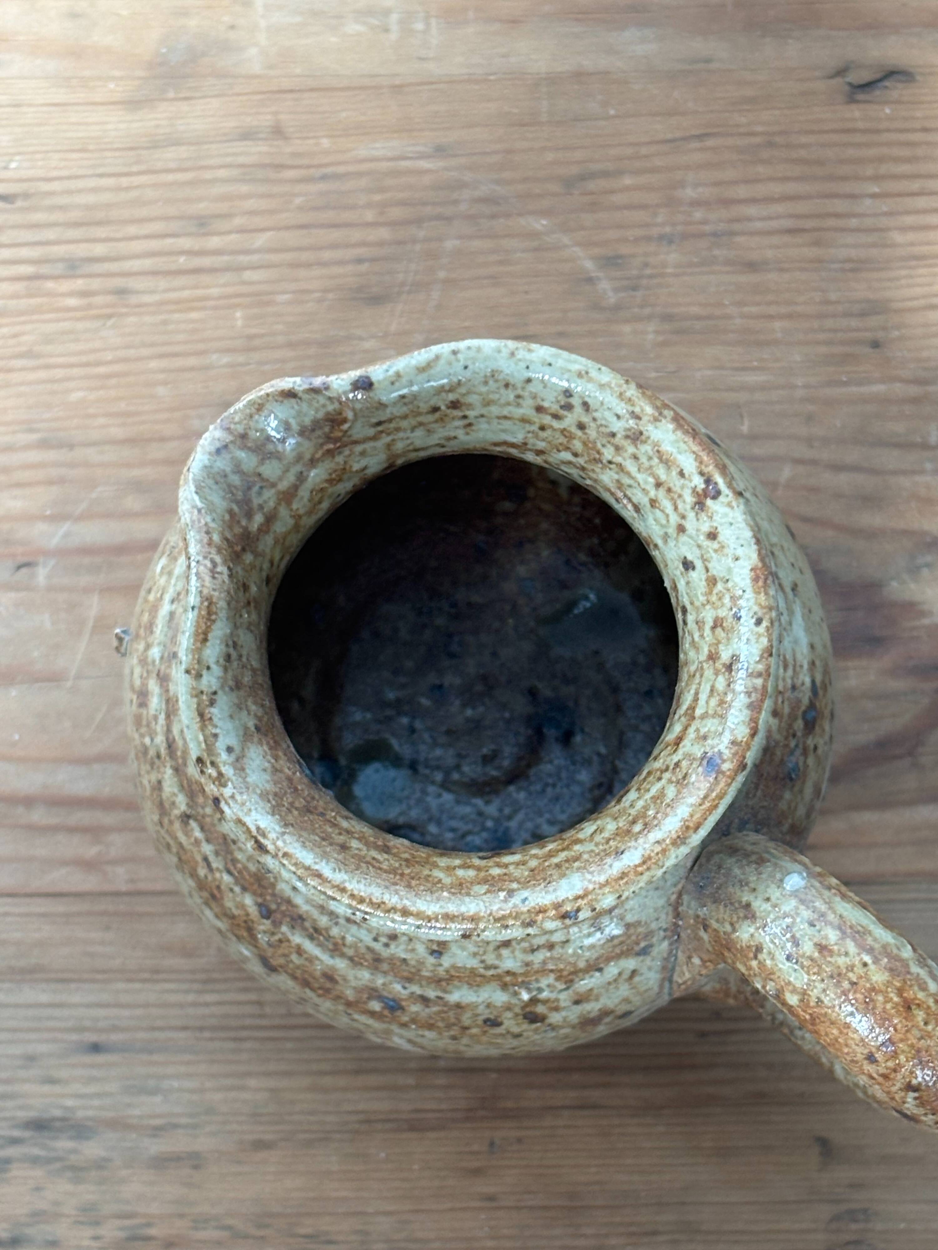 Small beige speckled stoneware pitcher