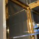Hollywood Regency style bookcase shelf, gilded brass and black lacquered wood, 1970