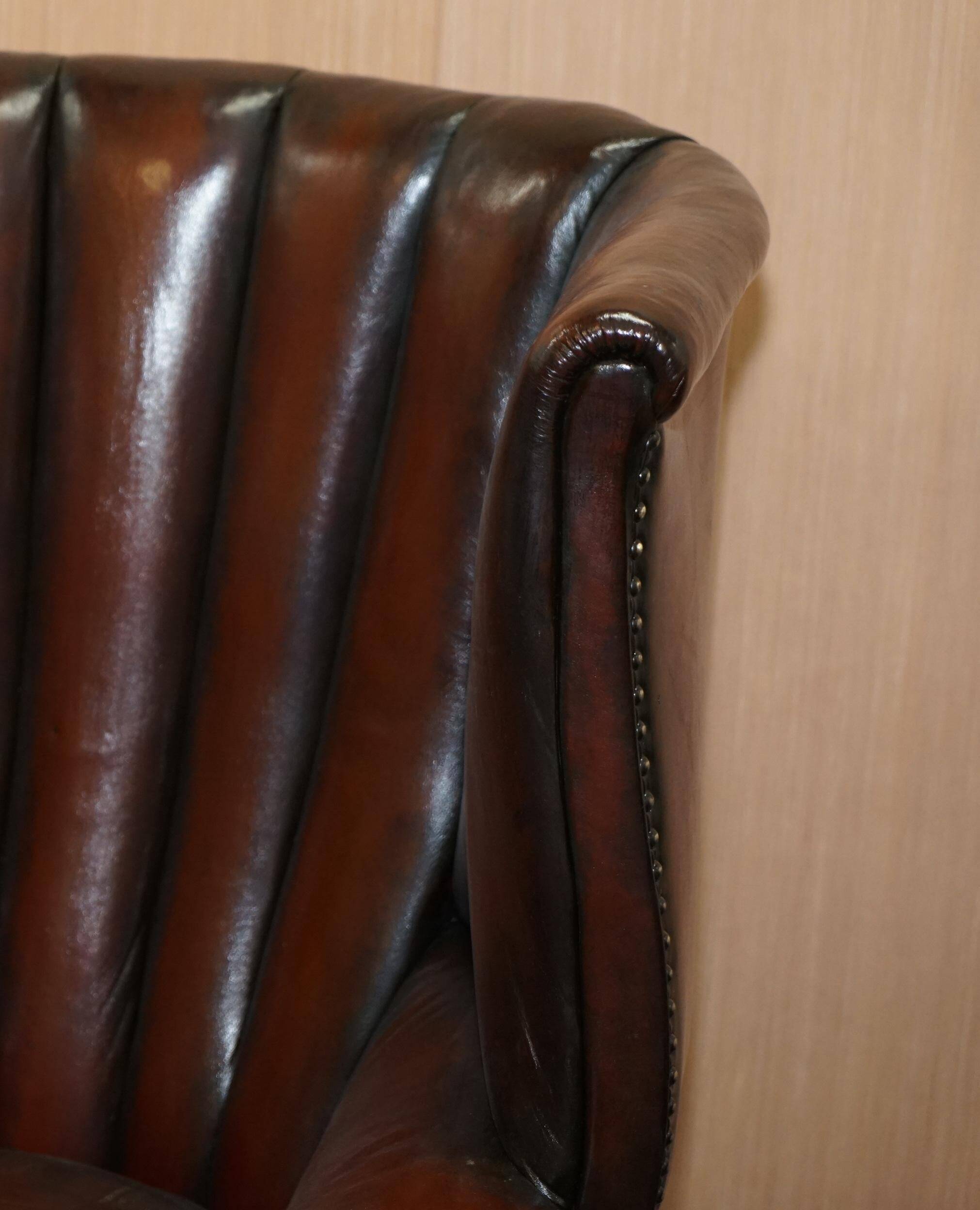 Victorian leather canapé and armchair, barrel back, circa 1860, restored.
