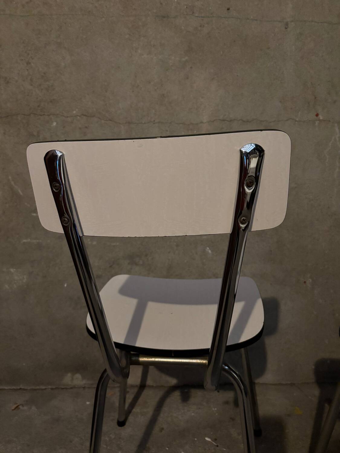 3 white Formica chairs