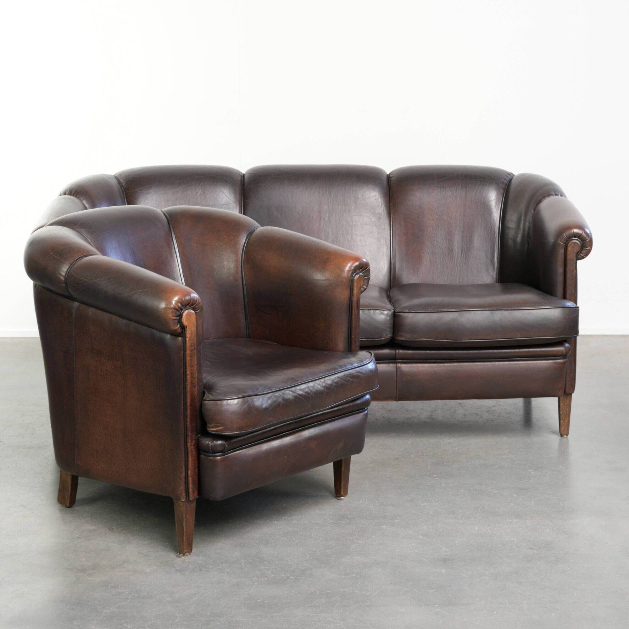 Set of a sheepskin sofa together with its matching club armchair