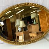 Vintage carved and gilded oval wall mirror
