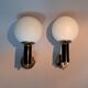Pair of wall lights in gilded and black lacquered brass, Italy 1970/1980.