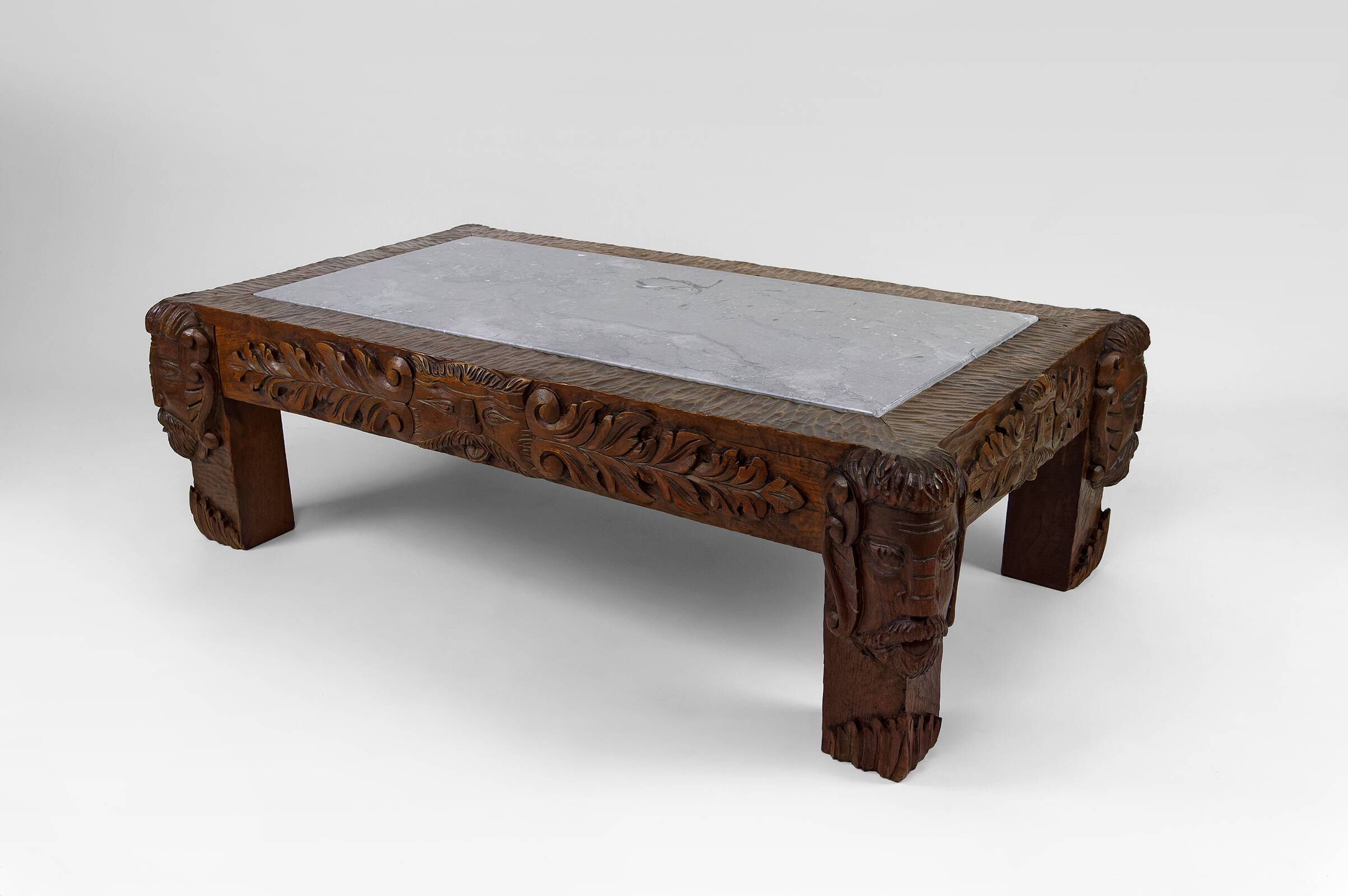 Solid oak coffee table carved with fauns and gray marble top, France, circa 1940