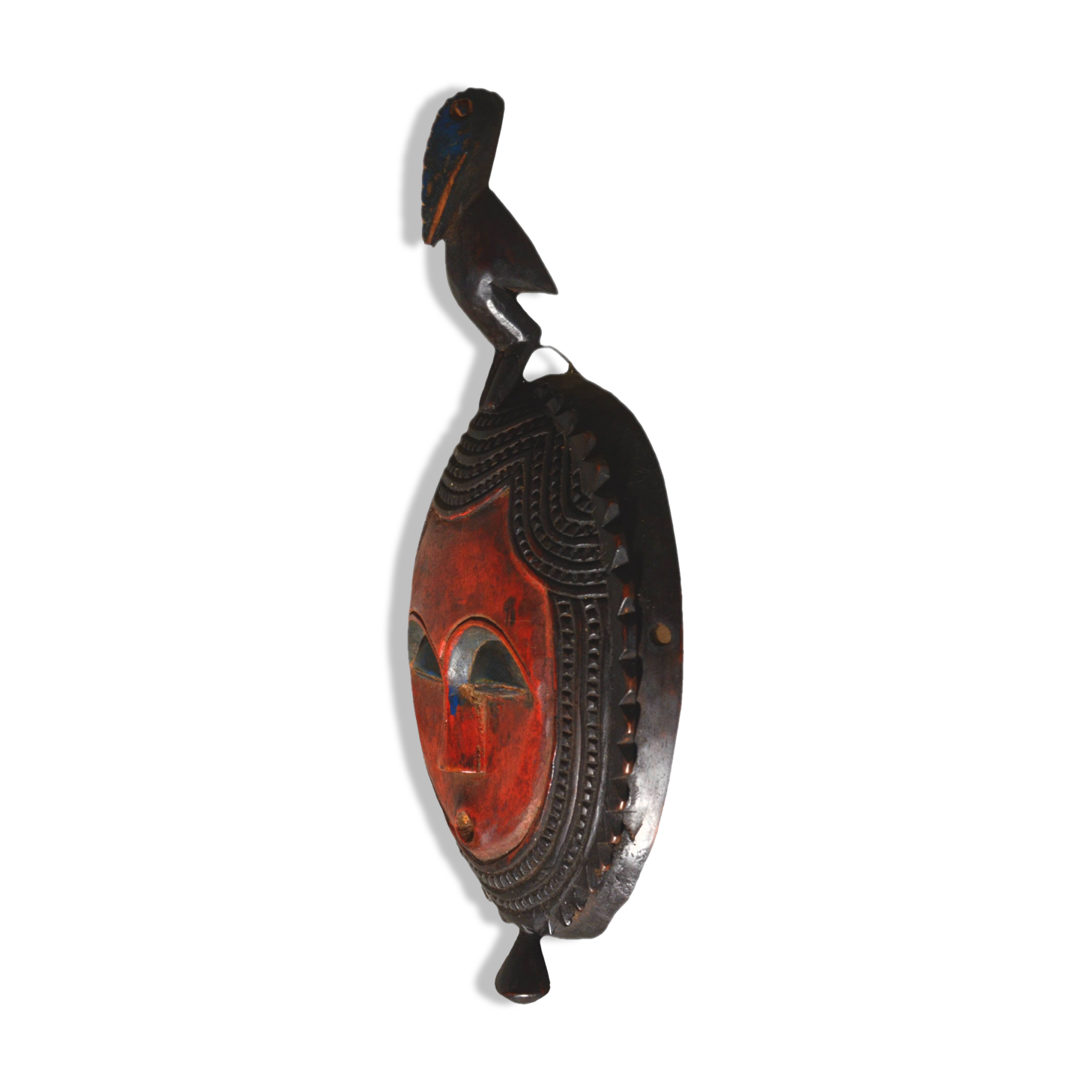 African wooden mask, face topped with a bird.