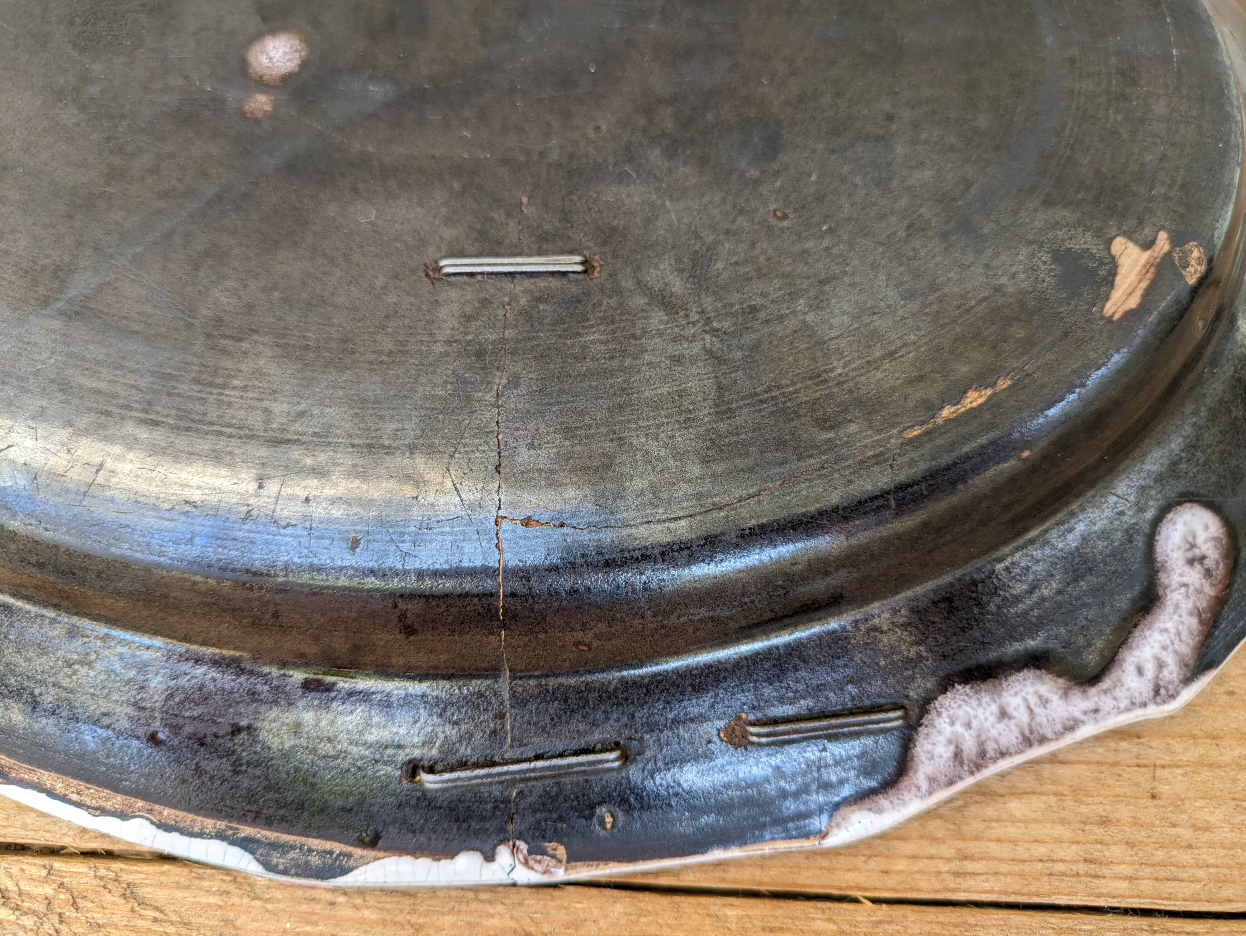 Old oval dish with floral motif called black bottom with staples