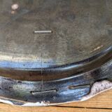 Old oval dish with floral motif called black bottom with staples