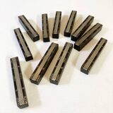 Set of 11 ebony wood knife rests with brass inlay