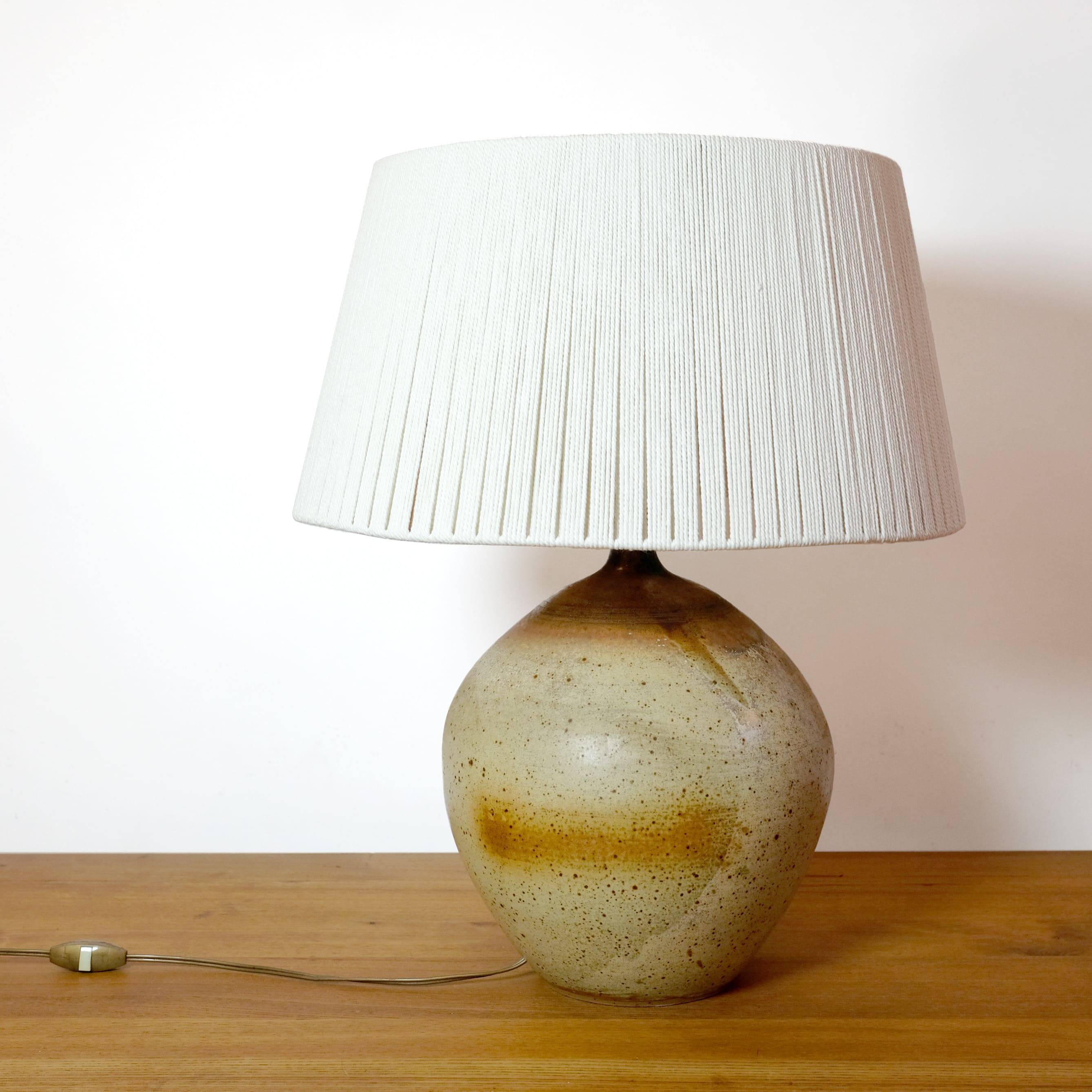 Large stone lamp with a cotton shade.