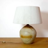 Large stone lamp with a cotton shade.
