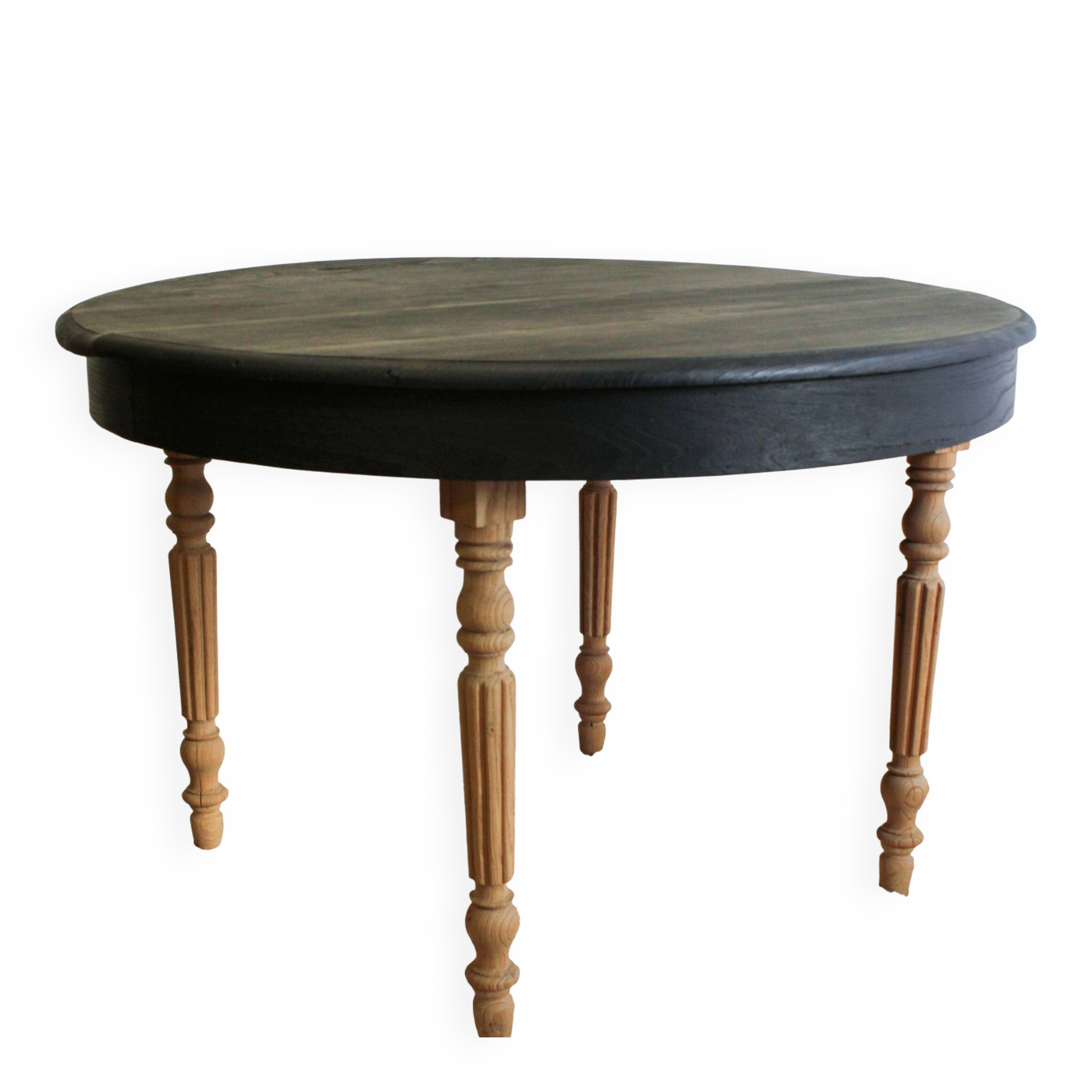 Round black dining table with oak wood.